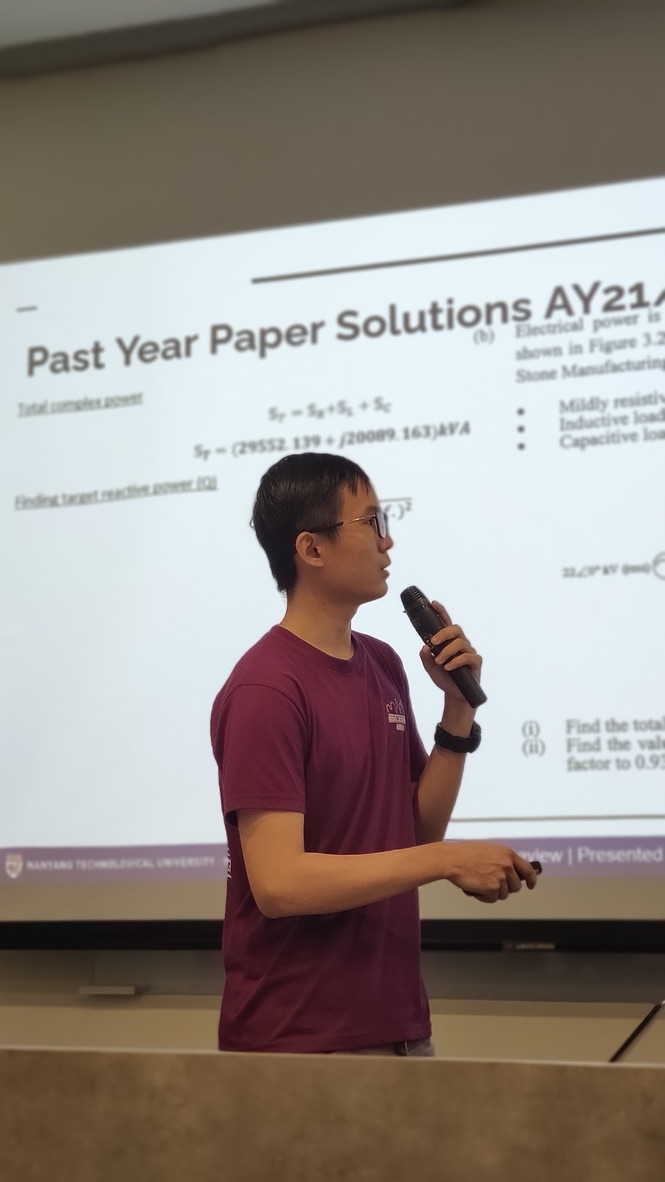Lee Wen Wei teaching Circuit Analysis with a projected examination solution