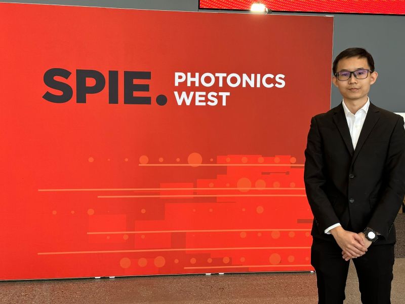 Wen Wei at the SPIE Photonics West sign in San Francisco